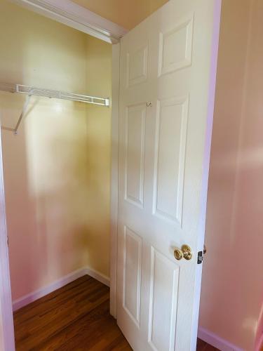 a room with a white door and a closet at Pipo’s perfect place in Jersey City