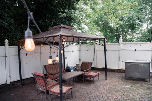 a gazebo with a table and chairs and a table and a table at Pipo’s perfect place in Jersey City