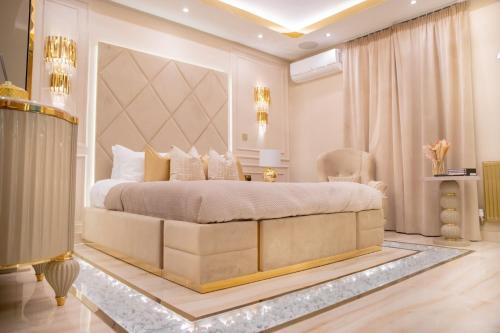a bedroom with a large bed with a large headboard at Alexandras Palace in Bradford