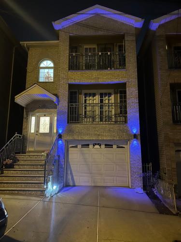 a house with a garage door with blue lights at Pipo’s perfect place in Jersey City