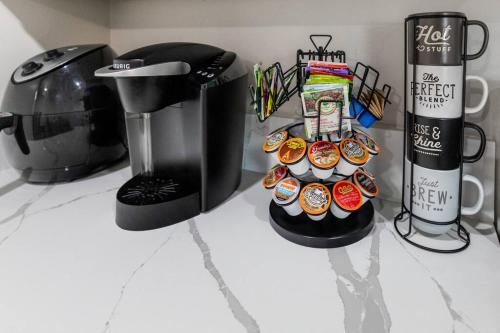 a counter top with a coffee maker and cupcakes at San Diego's Cozy Gem in San Diego