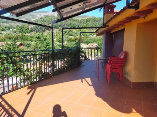 a view from the balcony of a house with a table and chairs at Hostal Yuste in Garganta la Olla