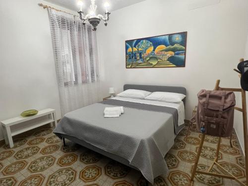 a bedroom with two beds and a painting on the wall at Casa Vacanze Al Vesuvio in Trecase