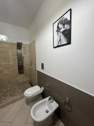 a bathroom with a toilet and a sink and a shower at Casa Vacanze Al Vesuvio in Trecase