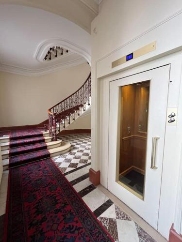 a hallway of a building with stairs and a rug at Studio Champs Élysées in Paris