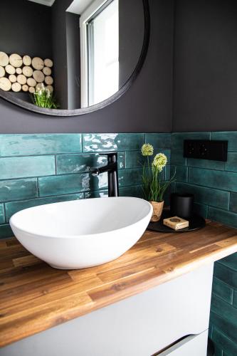 a bathroom with a large white sink and a mirror at Penthouse Wohnung mit Terrasse & Sauna - Wildecker Ferienbutze in Hönebach