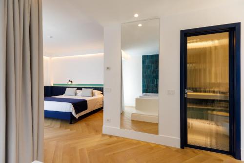 a bedroom with a bed and a large mirror at Grand Hotel Cesare Augusto in Sorrento