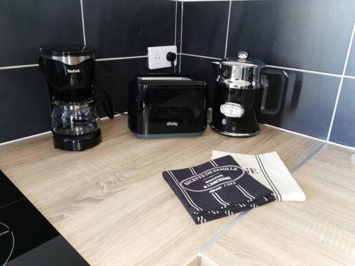 a counter with two coffee makers on a counter top at LE DEAUVILLE *T2 (40m²) *WIFI*PARKING PRIVE*CALME in Lourdes