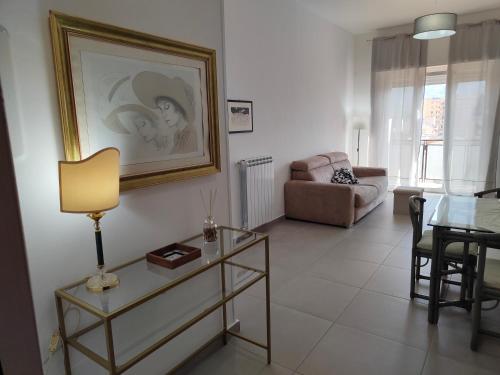 a living room with a table and a couch at GiErre Apartment in Termini Imerese