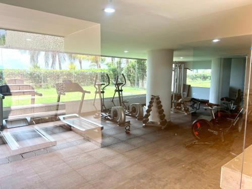 a gym with cardio equipment and a large window at Frente al mar Morros Epic 323 in Cartagena de Indias