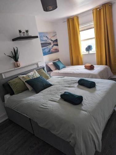 two beds with pillows on them in a bedroom at Holiday home in City Centre in Liverpool