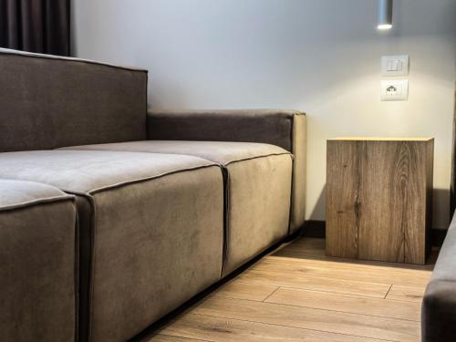 a room with a couch and a wooden table at ALEXANDER Rooms & Apartments in Durrës