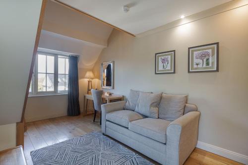 a living room with a couch and a table at The White Horse Hotel, Romsey, Hampshire - The Coaching Inn Group in Romsey