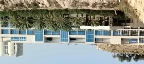 an aerial view of a building with palm trees at Alberni Jabal Hafeet Hotel Al Ain in Al Ain