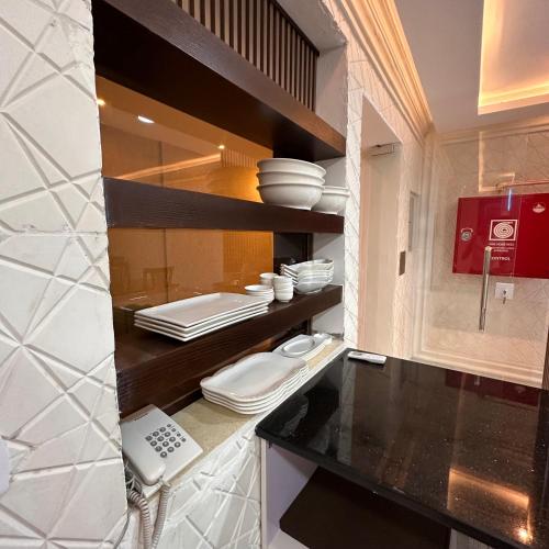 a kitchen with black and white counters and appliances at La Vie Boutique Hotel in Wadi Musa