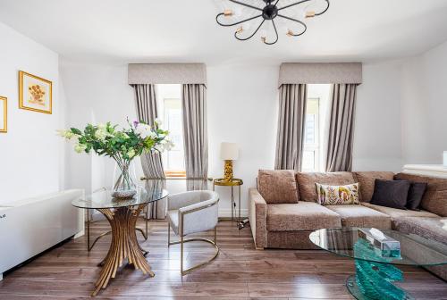 a living room with a couch and a table at CARLTON COURT - MAYFAIR in London