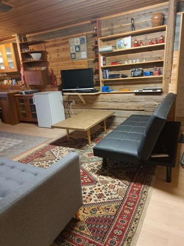 a living room with a couch and a coffee table at Guesthouse Nature Trails Sweden in Övre Älgestad