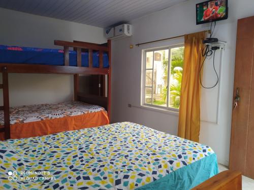 een slaapkamer met 2 stapelbedden en een raam bij Estancia Spondylus in San Lorenzo