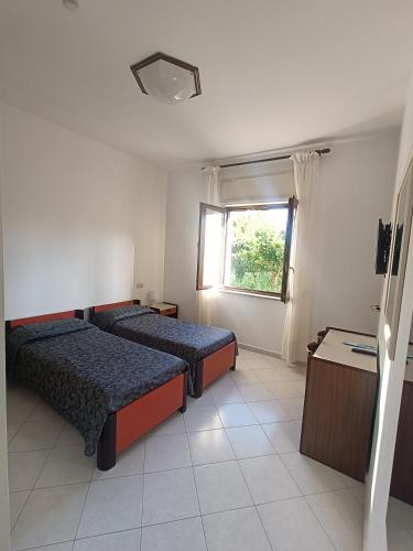 a hotel room with two beds and a window at Central Park in Massa Lubrense