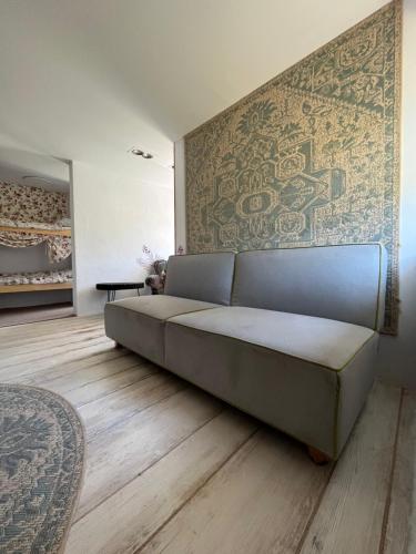 ein Sofa in einem Wohnzimmer mit einer Wand in der Unterkunft Mieszkanko in Gryfów Śląski
