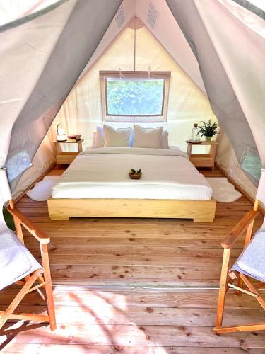 a bedroom with a bed in a tent at Glamping Tent Water Village Rogla in Oplotnica