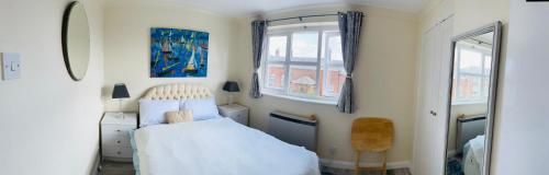 a bedroom with a white bed and a window at Serenity Station in Hornsea