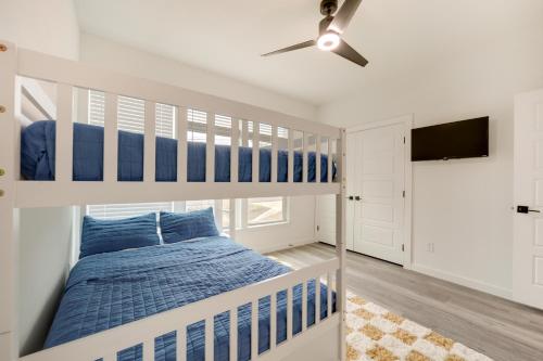 a bedroom with a bunk bed and a ceiling fan at Canyon Lake Oasis Backyard and Wraparound Deck! in Canyon Lake