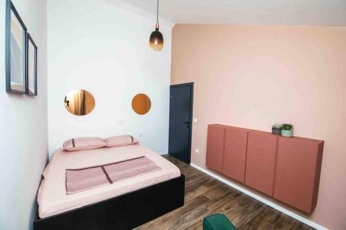 a bedroom with a bed with pink pillows on it at Holiday Home Sofia - quiet village&quick highway close to Biograd na Moru and Zadar in Benkovac