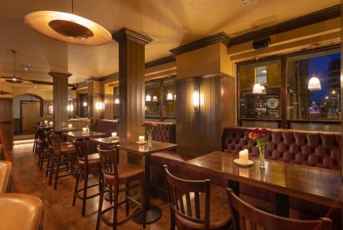 a restaurant with tables and chairs and a bar at McGettigan's Townhouse - Olives & Figs Bistro in Dublin