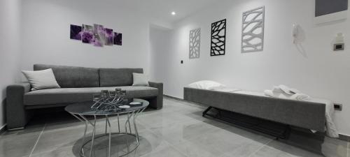 a living room with a couch and a table at KM LUXURY APART DOWNTOWN in Heraklio Town