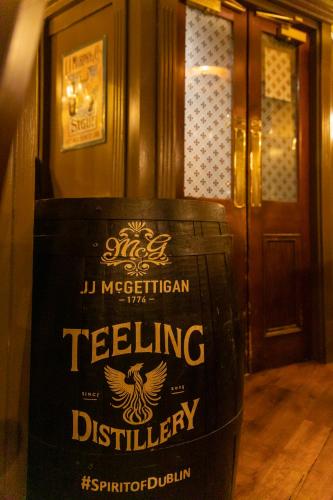 a wine barrel sitting in front of a door at McGettigan's Townhouse - Olives & Figs Bistro in Dublin