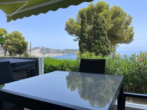 una mesa y sillas con vistas al océano en Seaside Spa Luxury Flat - Jacuzzi - Sauna - Sea view, en La Herradura