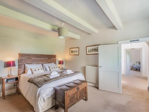 a bedroom with a large bed with a wooden headboard at The Glebe in Heckington