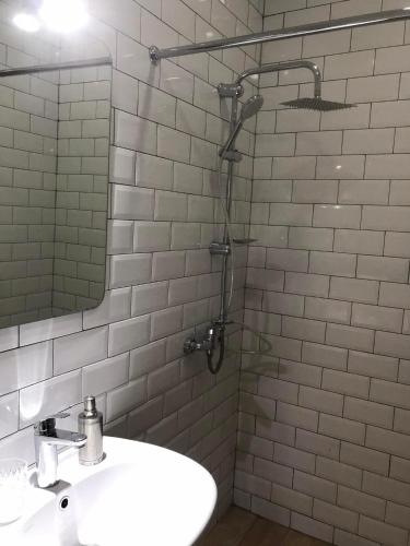 a bathroom with a sink and a shower at Aparthotel Old Avenue in Tbilisi City