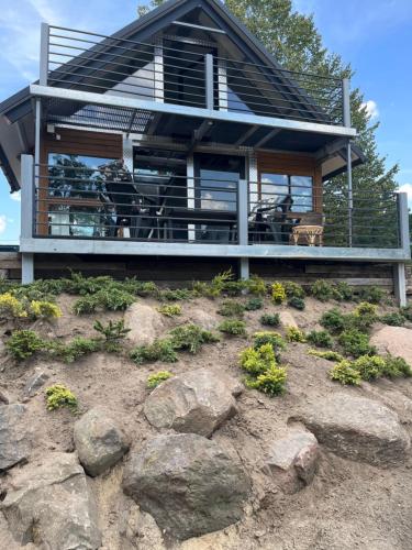 a house on top of a hill with rocks at Domek Survivalowy w Spale in Spała