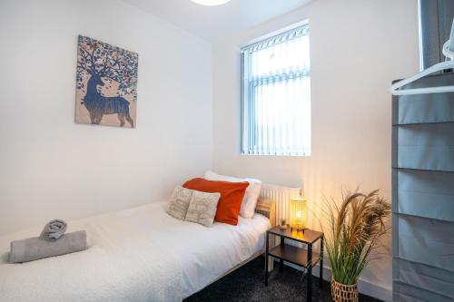 Habitación pequeña con cama y ventana en Medium long term stays welcome, en Heeley