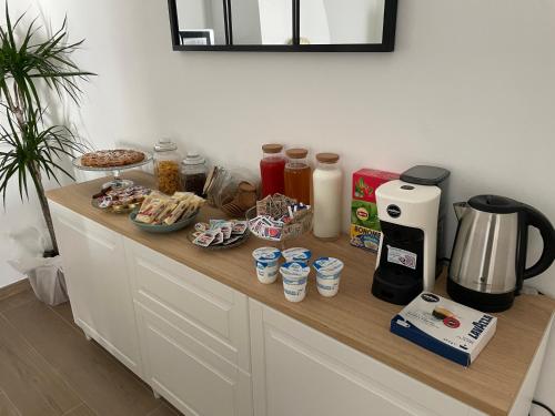 a counter with a coffee maker and food on it at A Casa dei Miei in Otranto