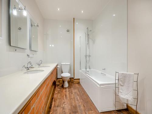 a bathroom with a sink and a tub and a toilet at The Stables - Uk44515 in North Thoresby