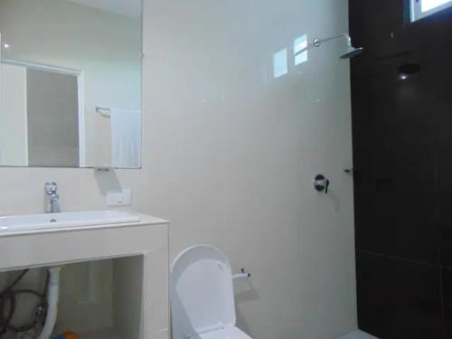 a white bathroom with a sink and a toilet at NFT in Cancún