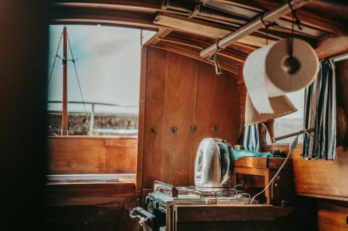 a kitchen with a stove and a boat at Vayu in Nida