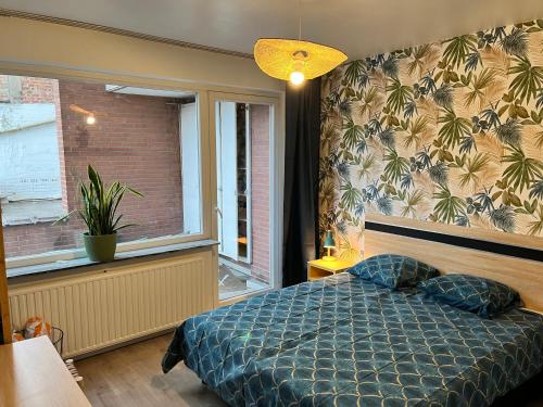 a bedroom with a bed and a window at Vilvoorde city center in Vilvoorde