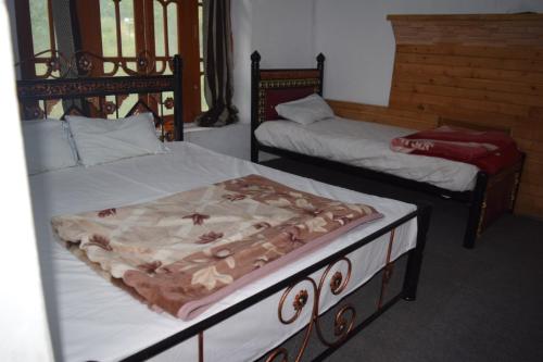 a bedroom with two beds at Siwakhat Huts in Shoghot