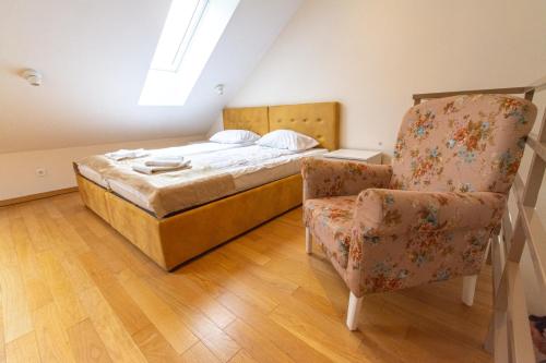 a bedroom with a bed and a chair at Urban Suite Zlatibor in Zlatibor