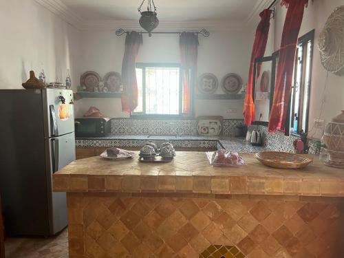 a kitchen with a counter top and a refrigerator at Chez Ali in Essaouira