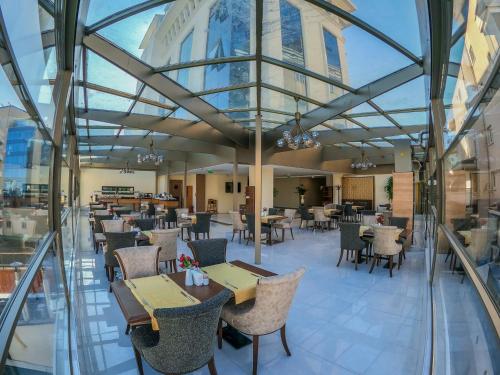 a view of a restaurant with tables and chairs at Akman Premium Hotel in Ankara