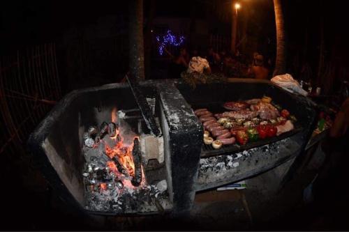 a grill with a bunch of food on it at Kin Hostal and Camping in Holbox Island
