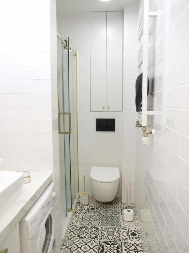 a bathroom with a toilet and a glass shower at Prague 9 apartments in Prague