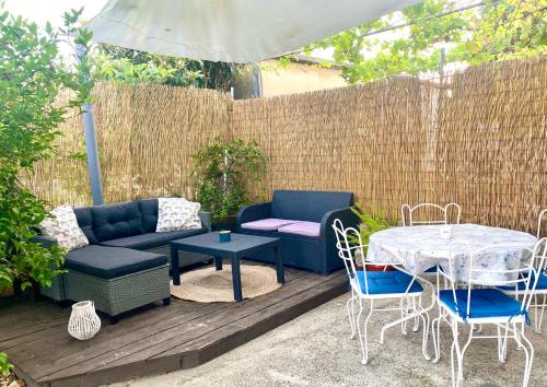 a patio with a blue couch and a table and chairs at Holiday Home Casa Bianca in Sukošan