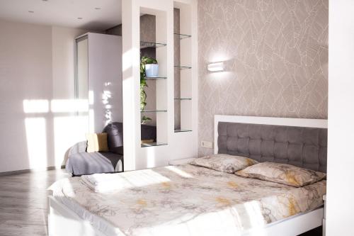 a bedroom with a large bed in a room at VIP Квартира на Науковій, аквапарк in Lviv