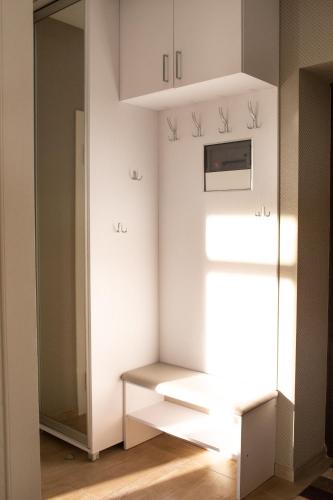 a small kitchen with white cabinets and a window at VIP Квартира на Науковій, аквапарк in Lviv